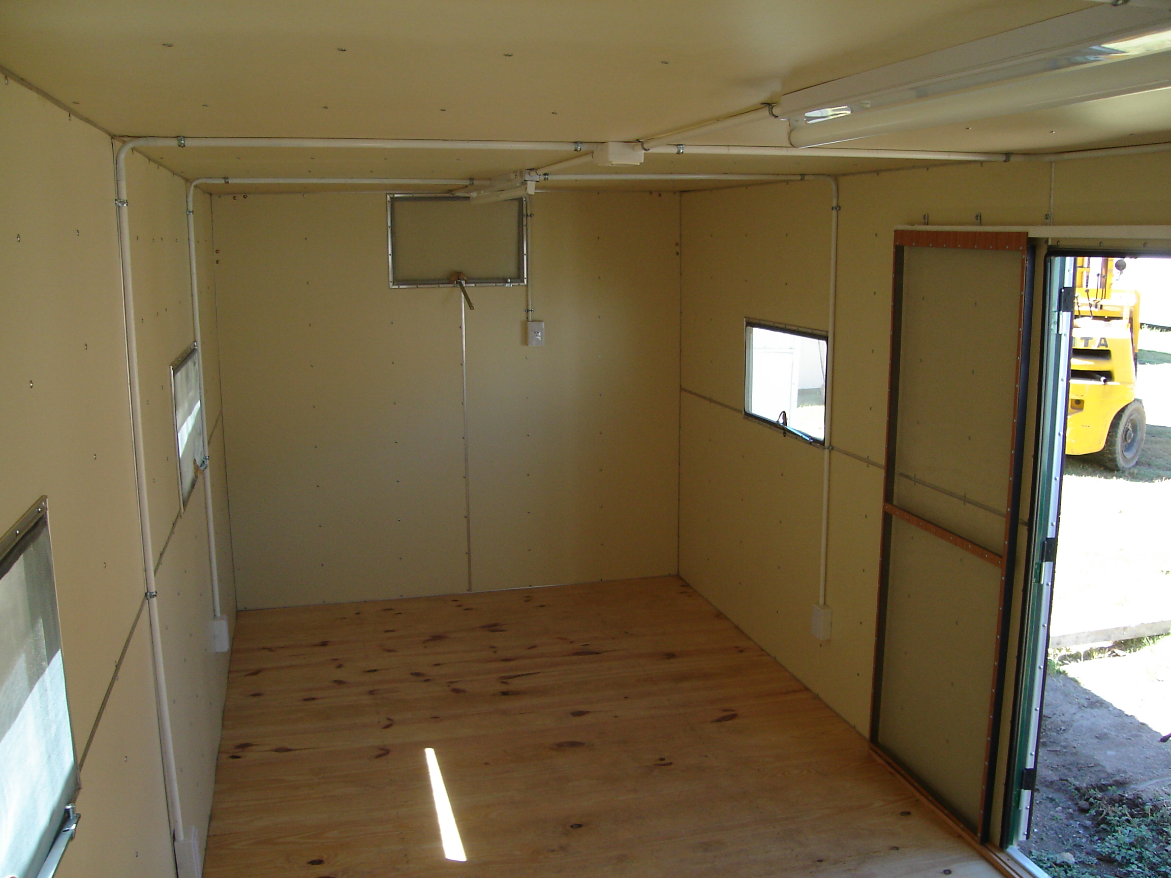 Interior de trailer petrolero tradicional con revestimiento claro y piso de madera